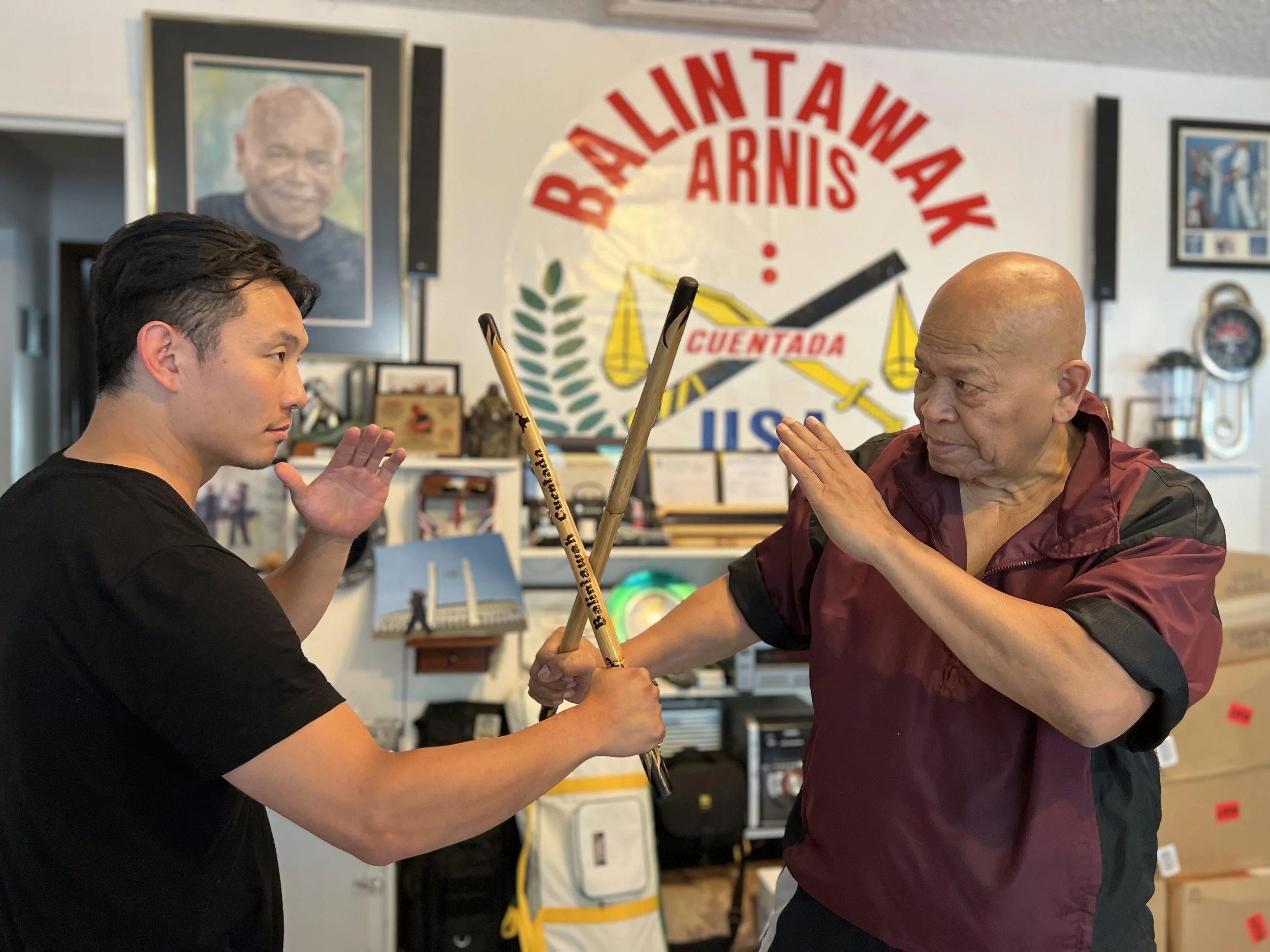 Guro Frank Zhong and Grandmaster Bobby Taboada crossing sticks
